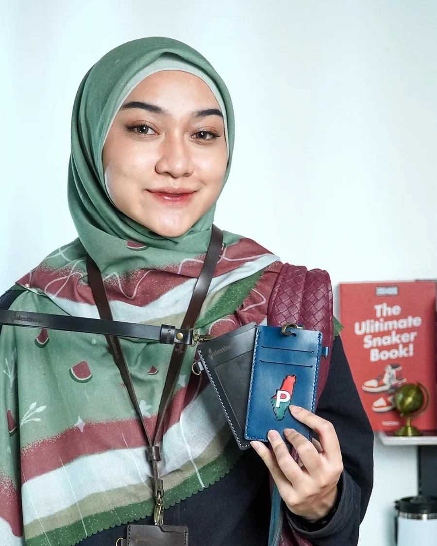 The ID card holder worn on its lanyard over a Palestina.id hijab