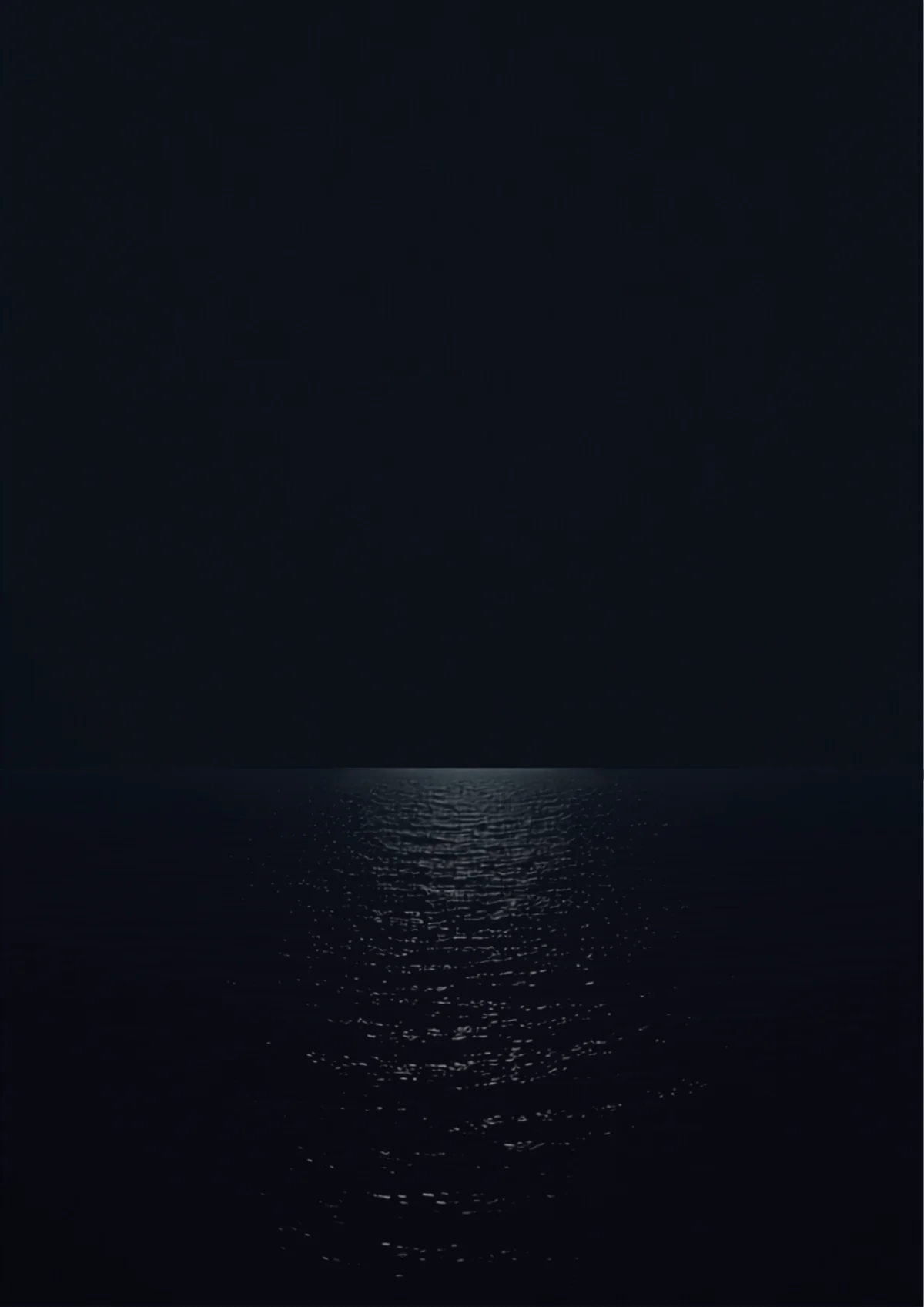 Open sea at night with a single band of moonlight