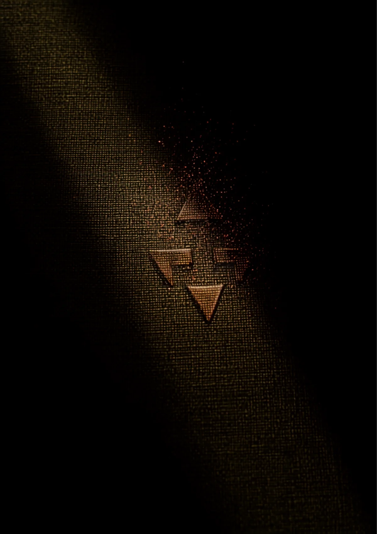 Tatreez cross-stitch on heavy linen under raking light